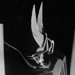 Packard Cormorant hood ornament in silver on a black background
