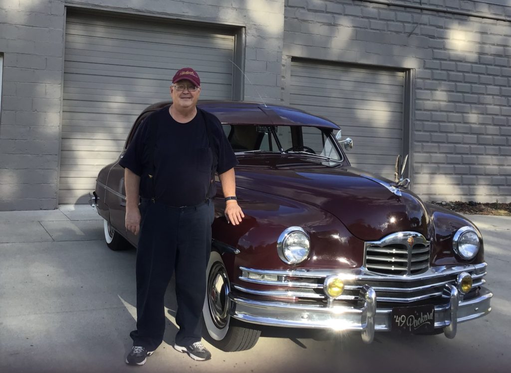 1949 Packard with a man next to it at the site of the former Quality Motor Sales, Wyandotte's Packard Dealer