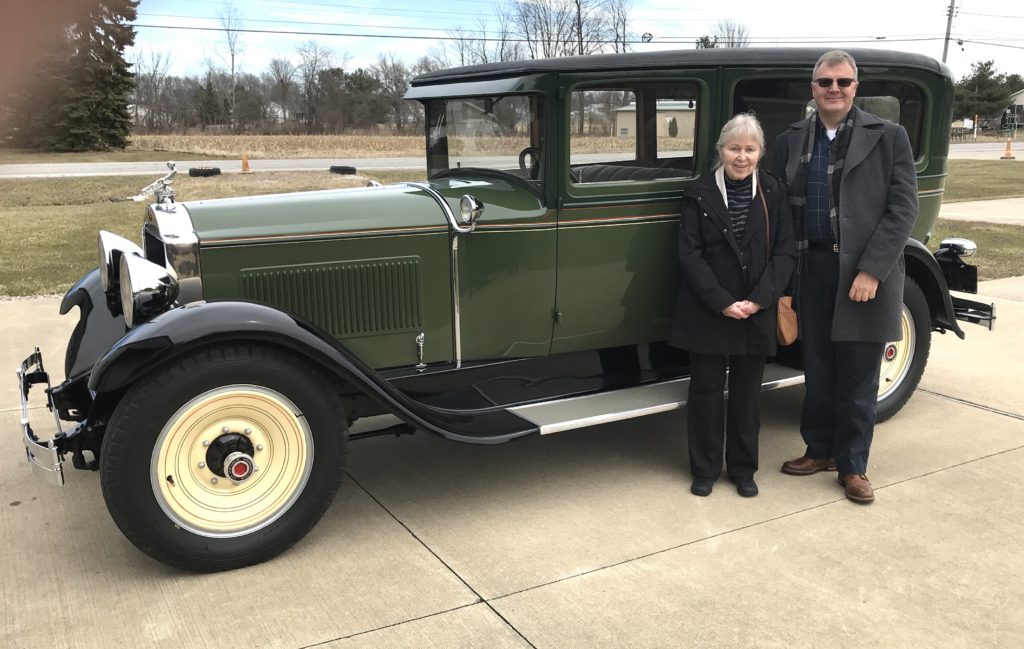 1929 Model 626 5-Passenger Sedan with a woman and a man next to it
