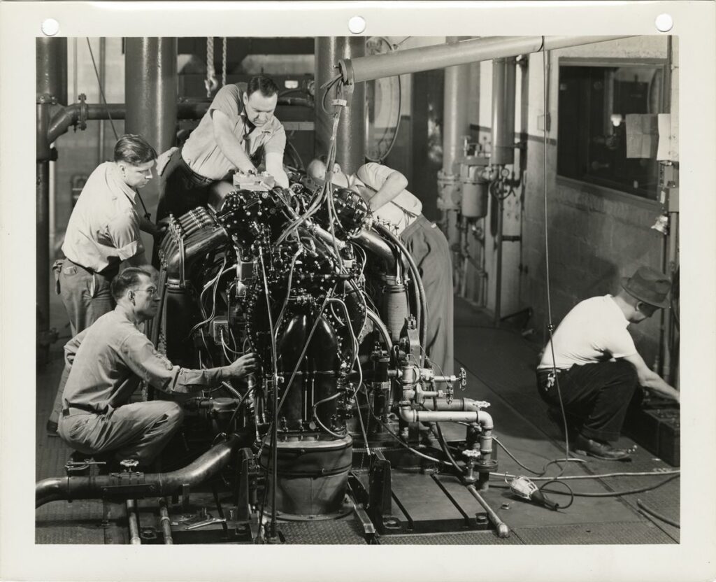 Detroit Packard aoto workers working on an engine in the plant